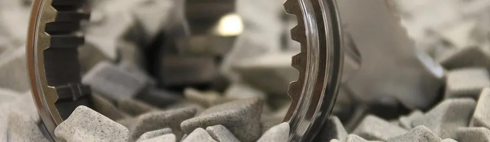 Polished metal gear in grey finishing media