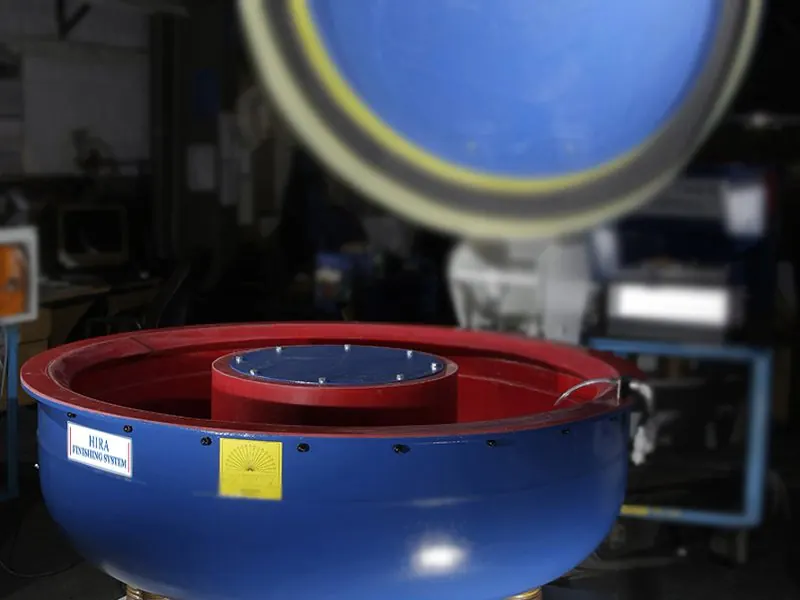Blue vibratory bowl finishing machine with red polyurethane lining